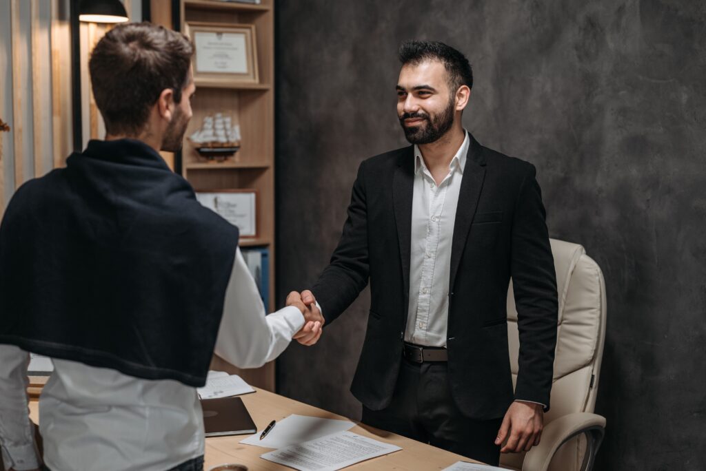 Business professionals discussing client documents in an office